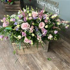 Pinks, purples and whites casket spray